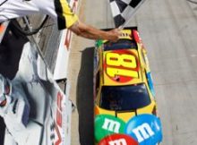 Kyle Busch crosses the finish line to get his second win of the weekend at Dover International Speedway and second NASCAR Sprint Cup Series win of the season. Credit: Todd Warshaw/Getty Images